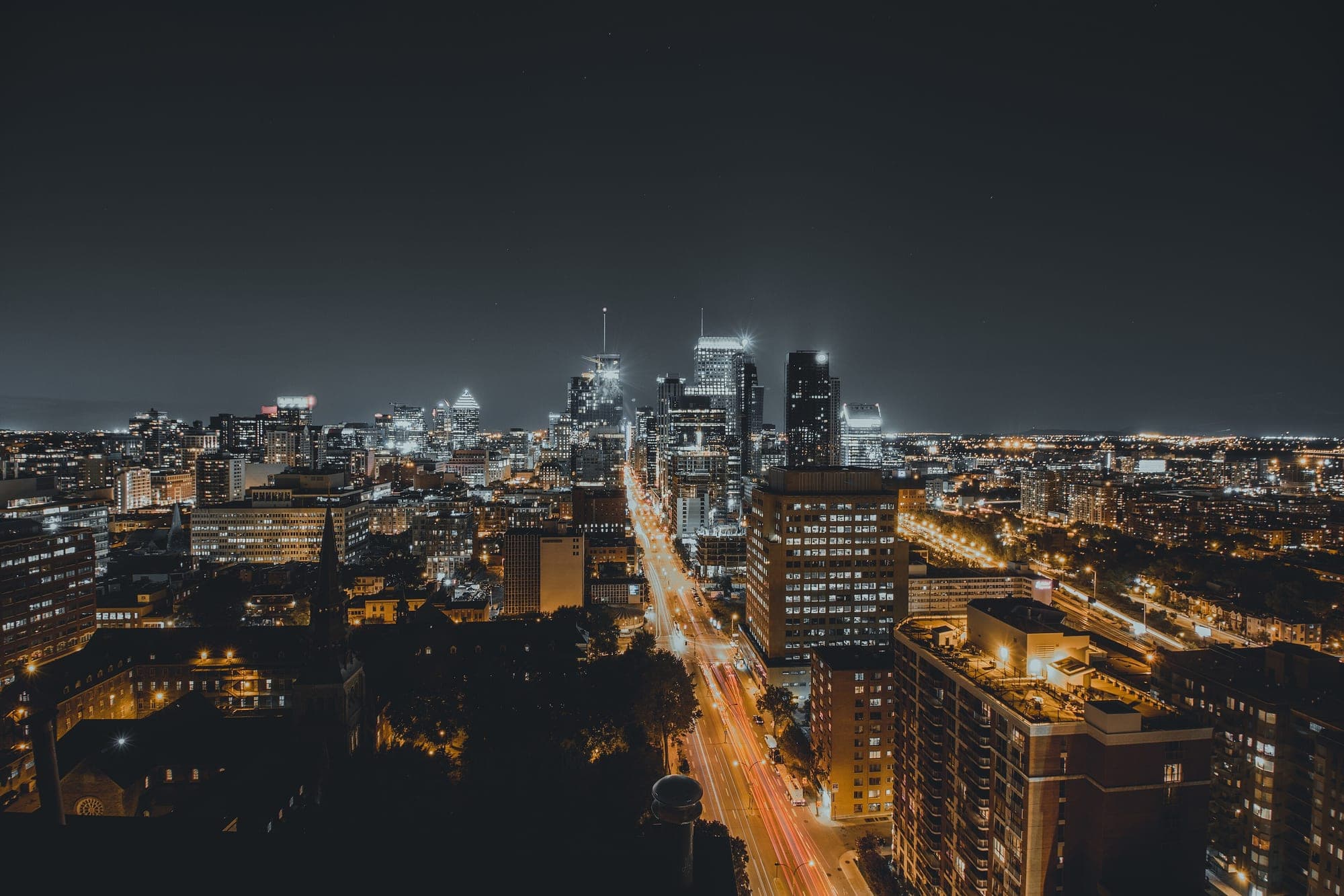 Downtown Montreal after dark, office towers lit above the traffic on Rene Levesque