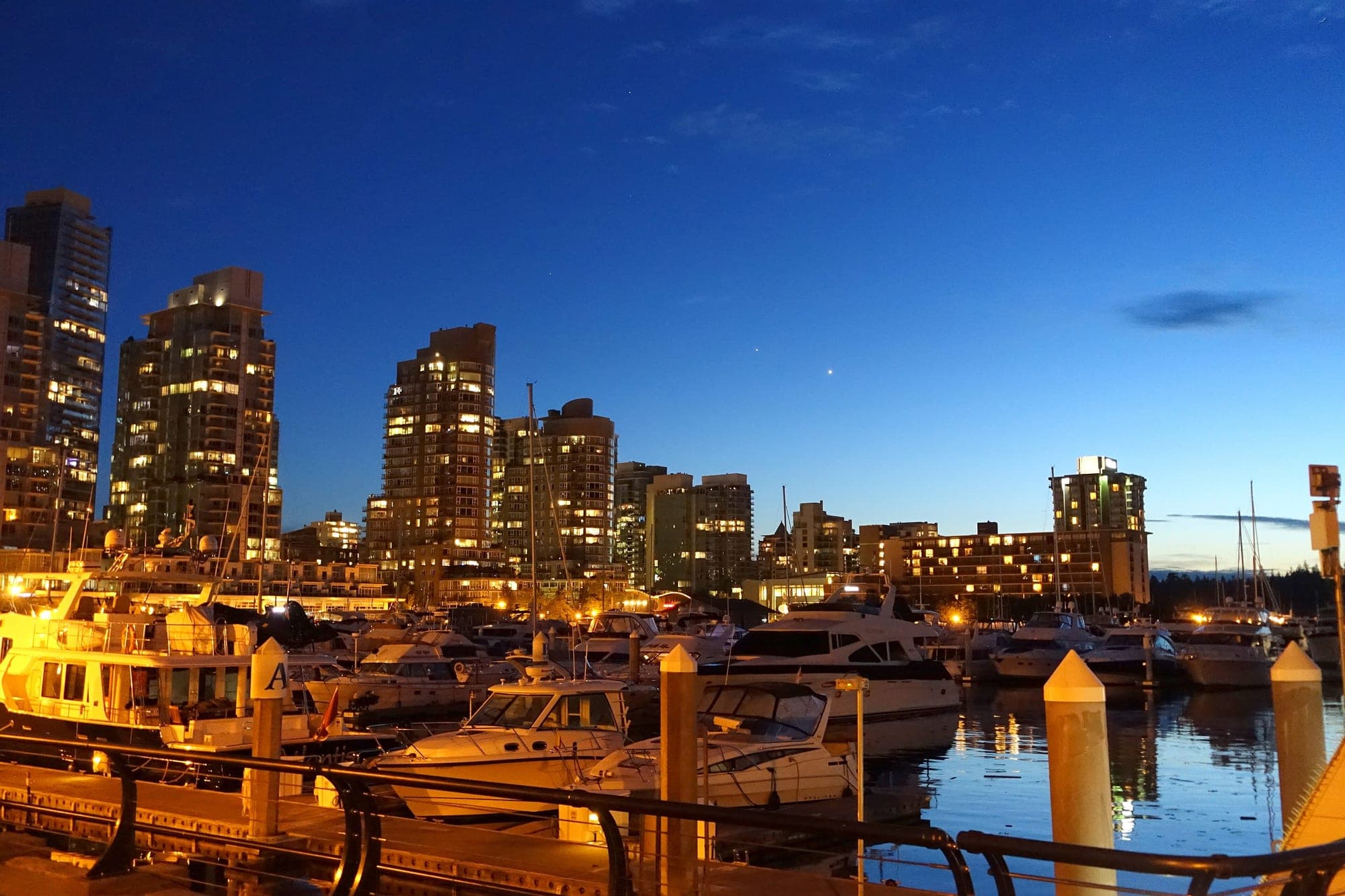 Vancouver towers above the Coal Harbour marina at blue hour